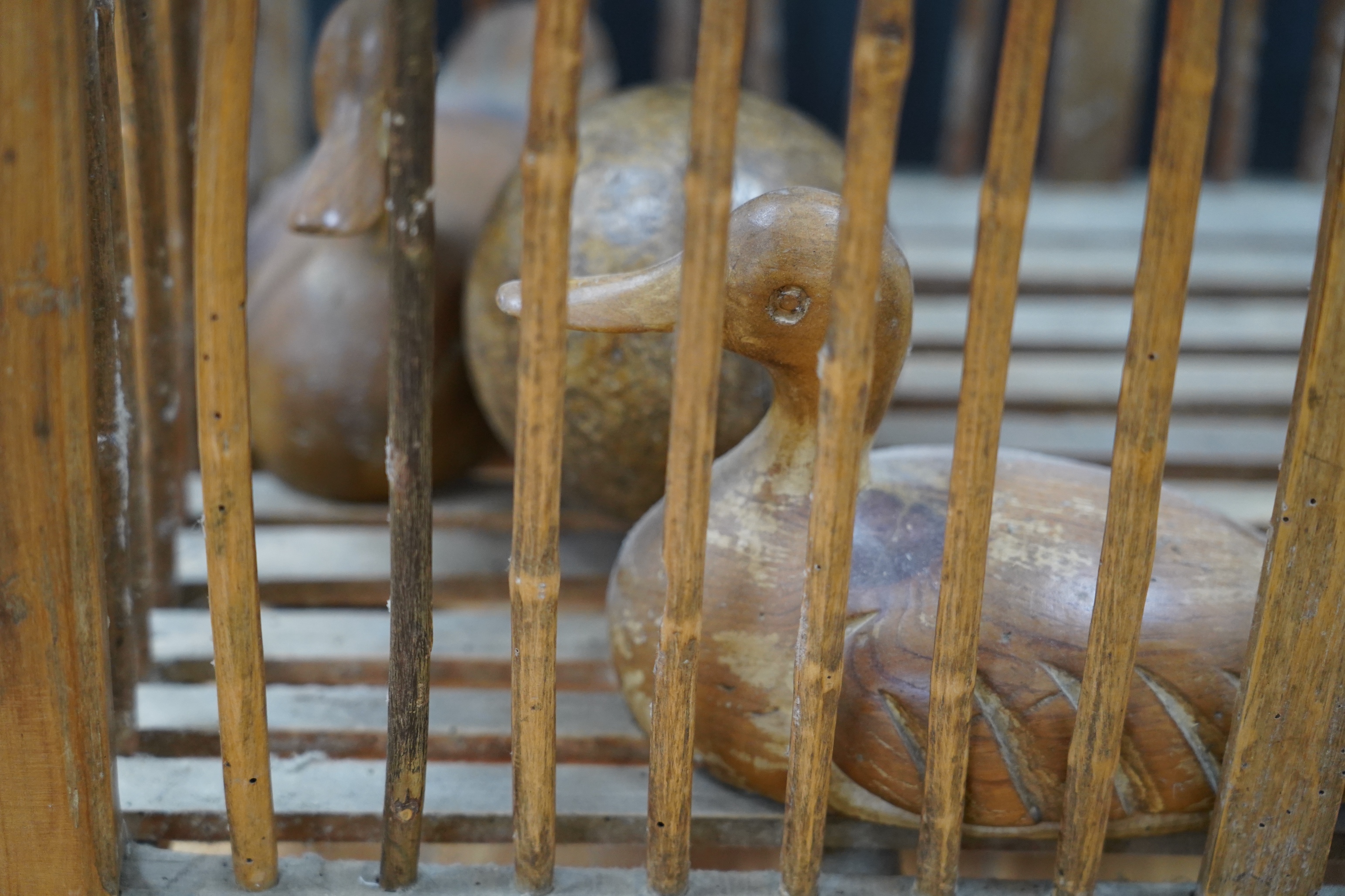 A large wooden chicken carrier with two carved ducks and two balls, chicken carrier 42cm high, 39cm wide, 53cm long